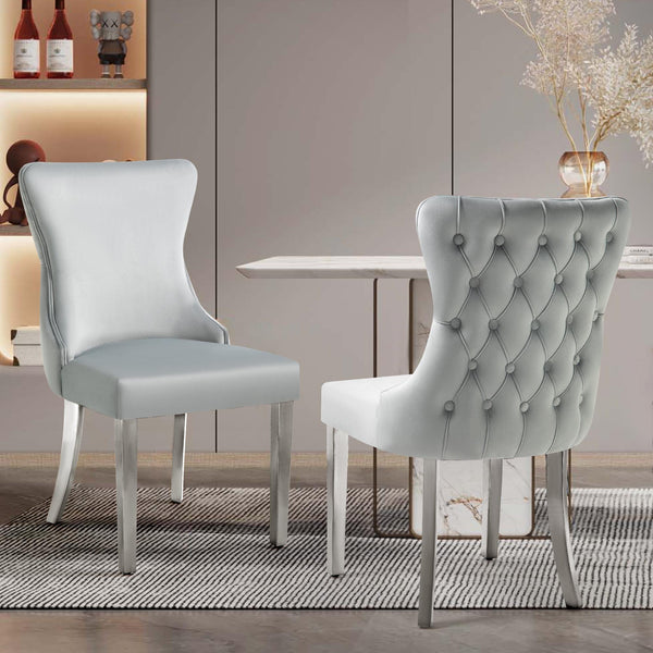 Pair of Paris light grey velvet dining chairs with tufted backs and silver legs, styled in a modern dining room.
