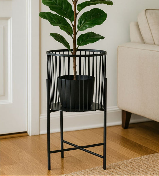 Black metal plant stand with a potted plant in a living room setting.