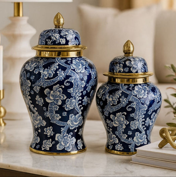 Two blue decorative vases with gold accents on a marble surface.