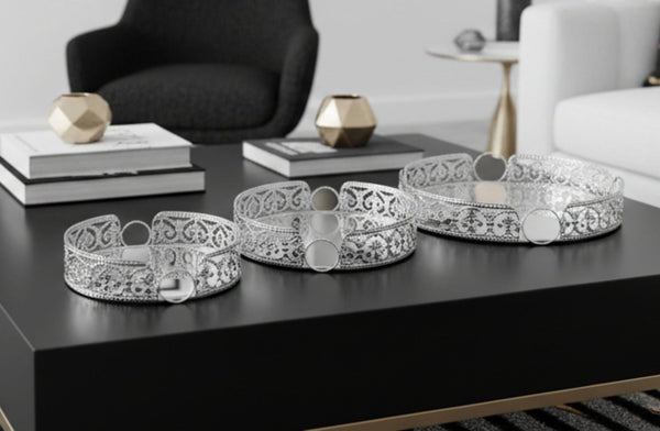 Decorative silver round tray set on a black surface with a modern interior background
