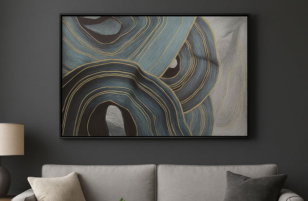 Abstract art piece on a dark wall above a gray sofa