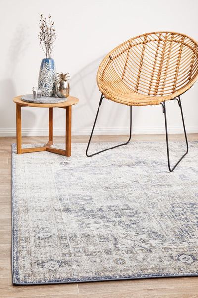 Mayfair Hugo Ocean Rug styled with rattan chair and side table