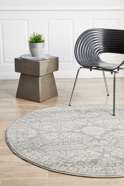 Stylish room setting with round Mirage 358 Silver Rug and contemporary grey furniture