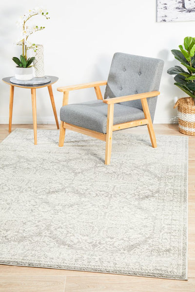 Elegant Mirage 358 Silver Rug styled in a modern room with grey armchair