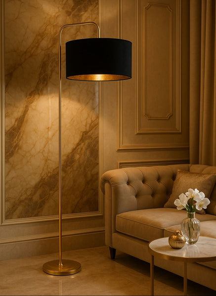 Decorative floor lamp with a black shade in a room with a couch and table.