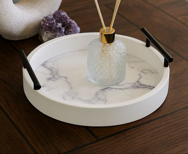 Marble-patterned tray with black handles on a wooden surface