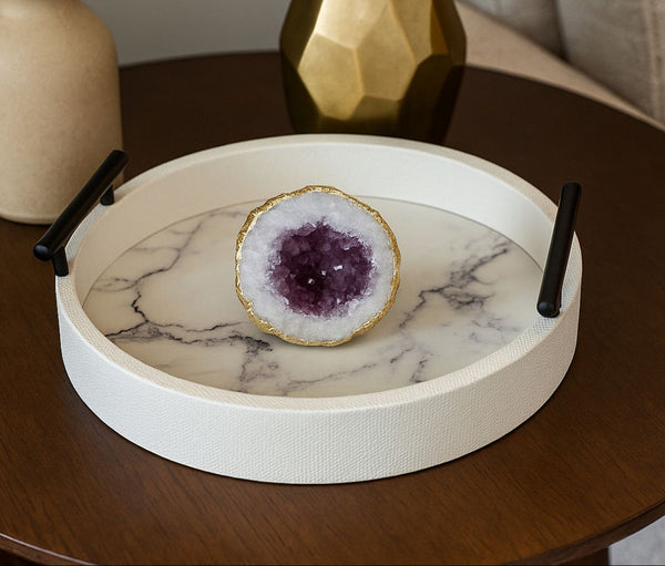 Marble-patterned white tray with a decorative stone on a wooden surface