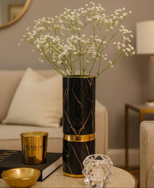 Decorative marble vase with flowers on a table in a living room setting