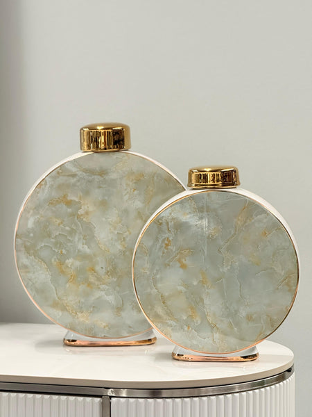  Marble Vases in gold and grey with round bodies and metallic gold tops – styled on a modern display table for elegant interior décor