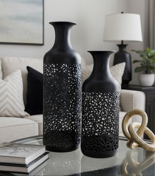 Black decorative vases on a table in a living room setting