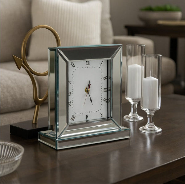 Decorative Mirror clock on a table with candles and a mirror in the background