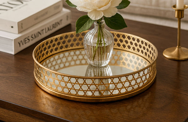 Gold decorative mirror tray with a vase of flowers on a wooden surface