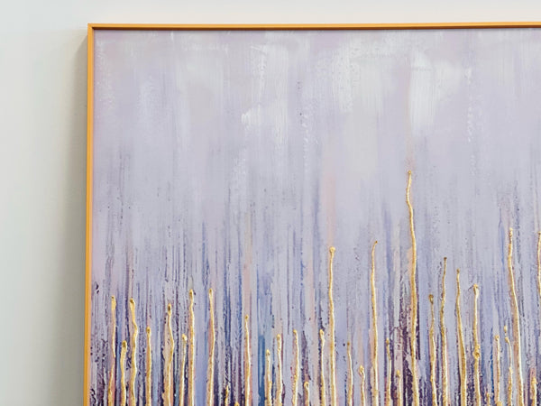 Close-up of gold-framed canvas showing textured gold streaks over a blue and lavender gradient background.