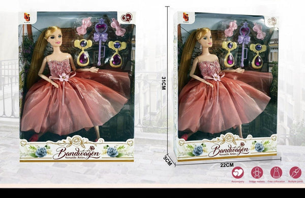 Princess doll with accessories wearing pink gown inside packaging with detailed design.