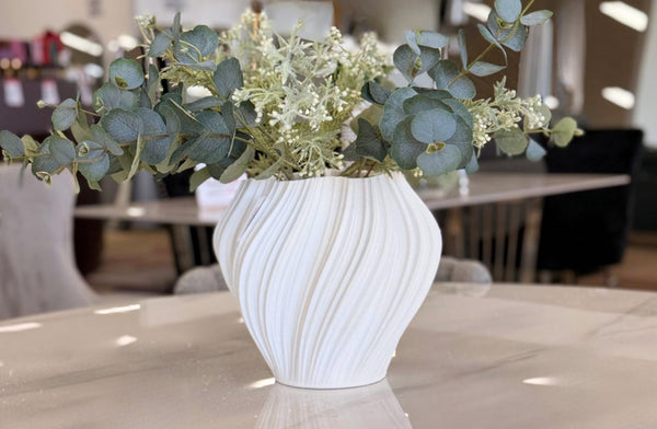 Quinn 3D print vase displayed on dining table with greenery in a modern interior setting.