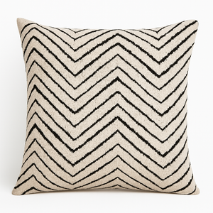 Reese luxury cushion featuring bold black chevron pattern on textured woven fabric.