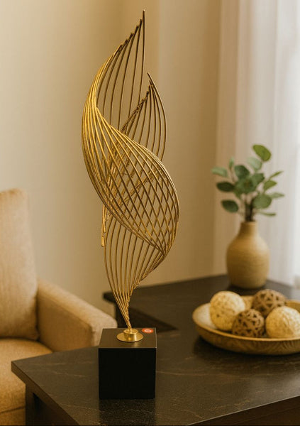 Decorative gold leaf sculpture on a table with a blurred background