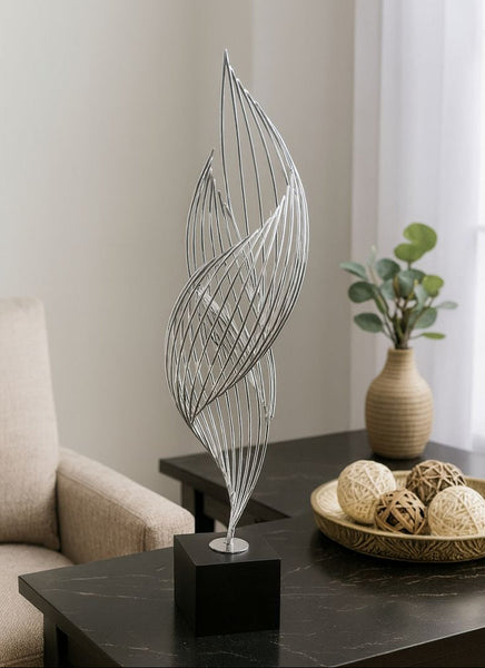 Decorative leaf sculpture on a table with a neutral background