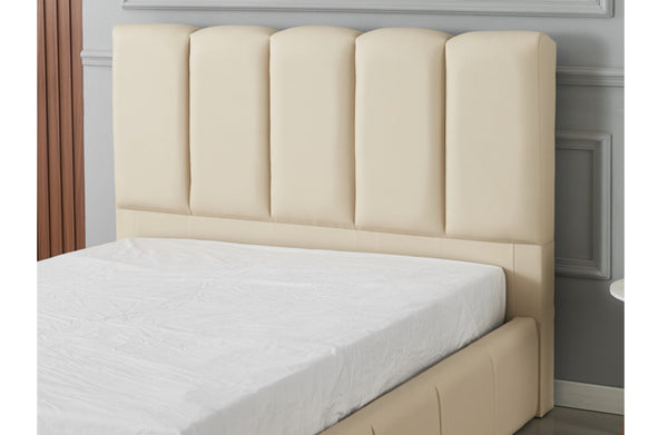 Close-up of Riley beige PU leather bed showing padded vertical headboard panels and soft finish.