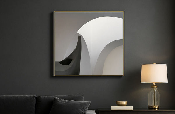 Abstract art piece on a dark wall with a lamp and decorative items below.