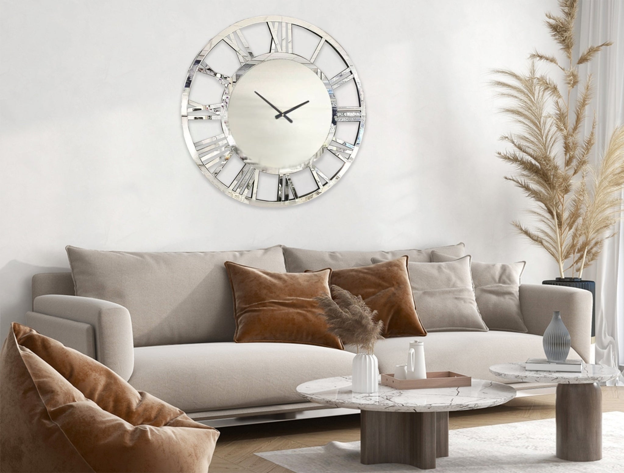 Silver mirrored Roman numeral clock styled in modern living room, chic wall décor accent.