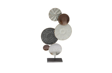 Modern abstract table décor with circular designs in brown, white, and grey tones.