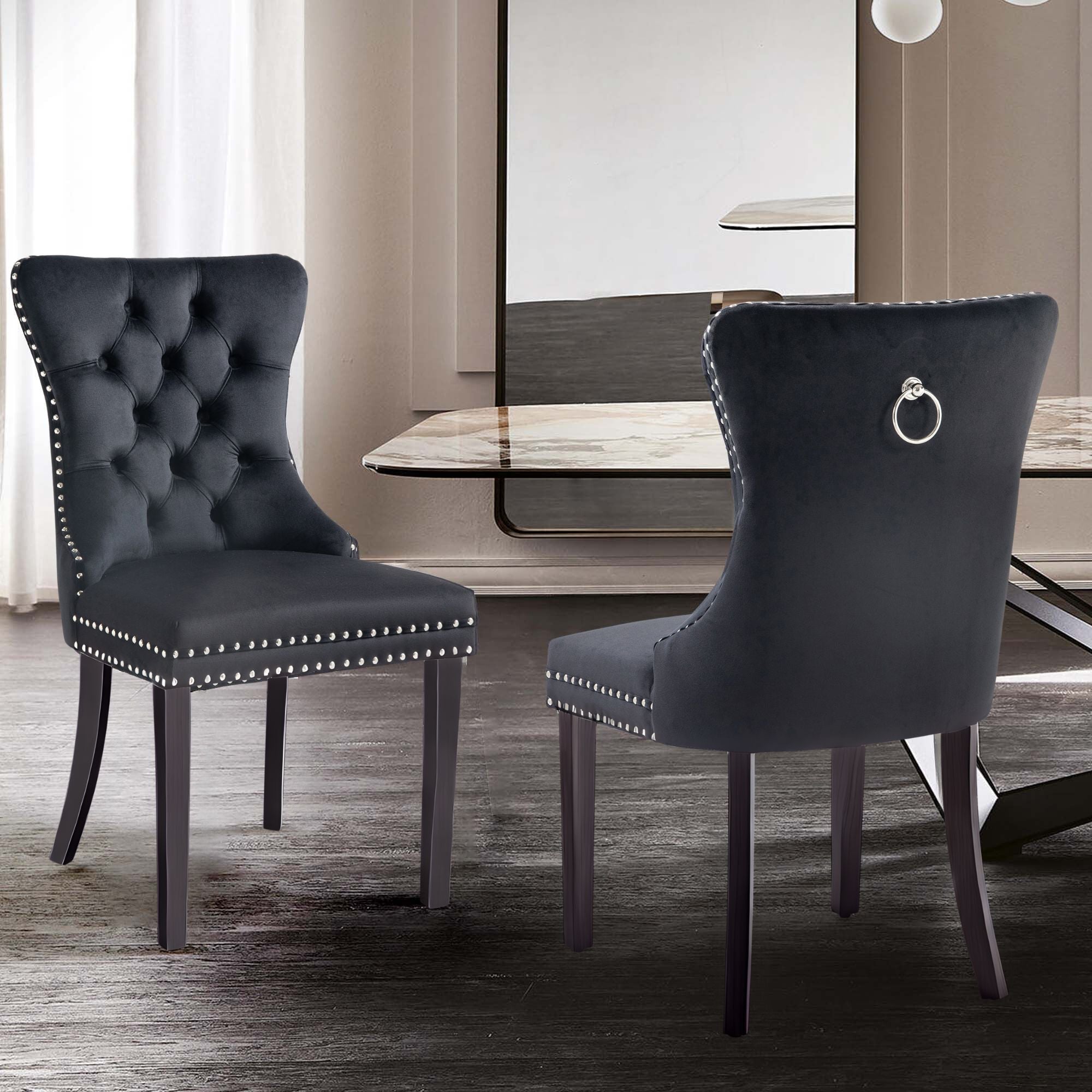 Alsea black velvet dining chairs arranged in contemporary dining room with modern décor.