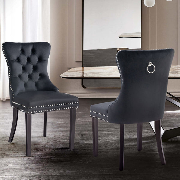 Alsea black velvet dining chairs arranged in contemporary dining room with modern décor.