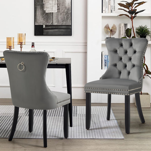 Alsea dark grey velvet dining chairs styled in modern dining room with table setting.