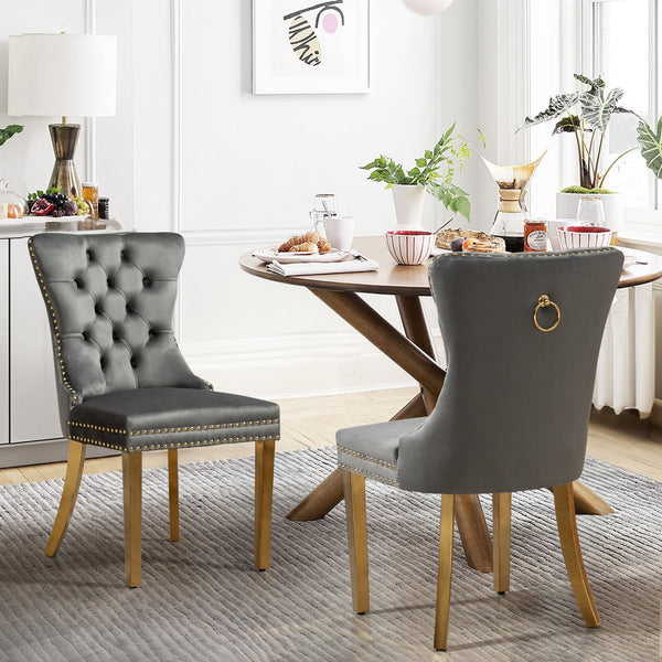 Elegant Alsea dark grey velvet dining chairs with gold legs styled in a dining space