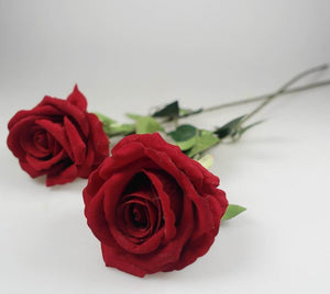Realistic artificial red roses laid flat – elegant floral décor