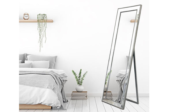 Free standing silver beaded framed mirror styled with bright white bedroom décor.