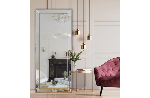 Medium gold beaded framed mirror with elegant gold accents in lounge setting.