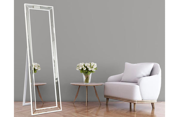 Tall white beaded mirror with floor stand styled beside chair and table in lounge