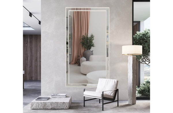 Oversized vertical white beaded framed mirror styled against wall in luxury living room