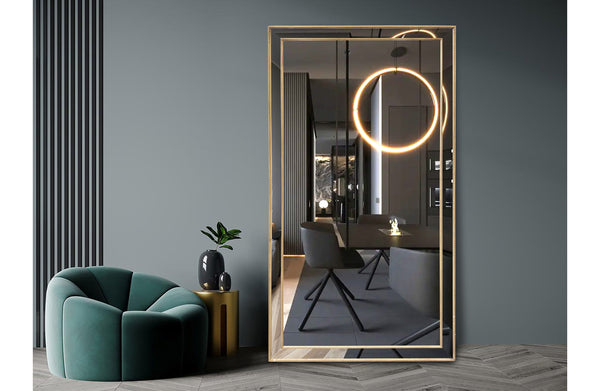 Beaded large gold framed mirror styled in a dark modern living room with accent chairs.