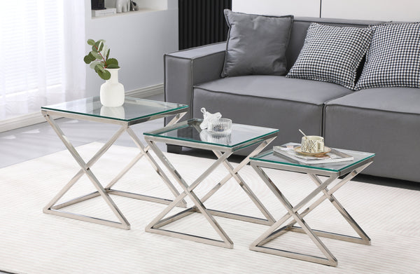 Bella set of three side tables with polished silver frame and clear glass tops in lounge.