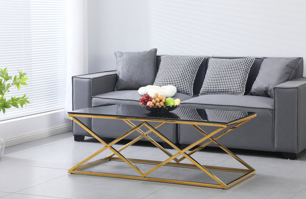 Beverly coffee table in gold polished frame with black glass top, bold luxury style.