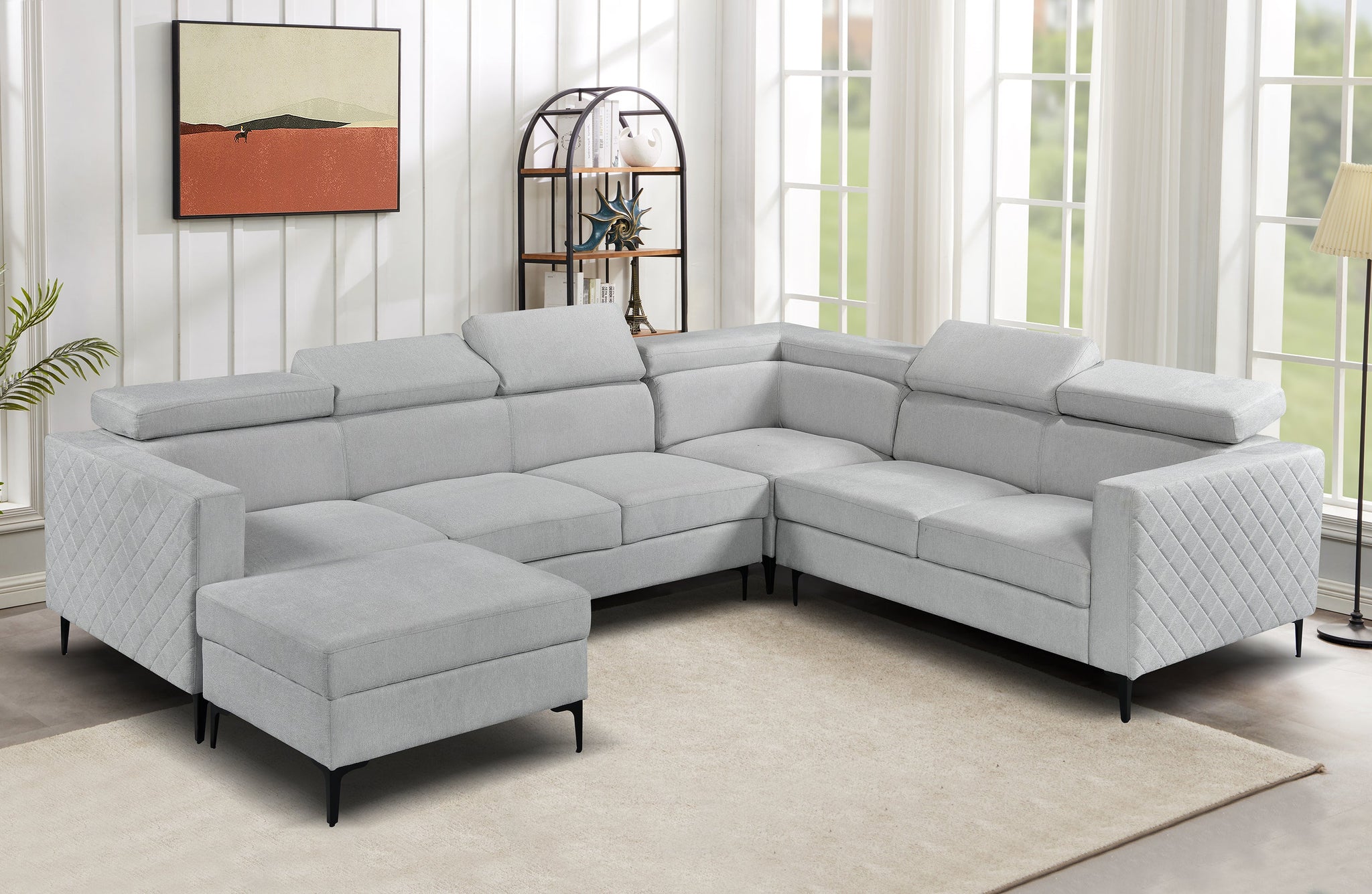 Light grey Boston modular lounge styled in living room with storage ottoman and adjustable headrests.