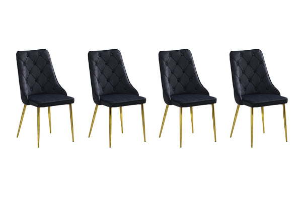 Set of 4 black velvet button tufted dining chairs with gold legs displayed in row.