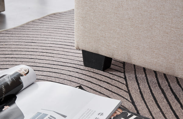 Detail of Cambridge Bed sturdy black legs with beige linen frame finish.