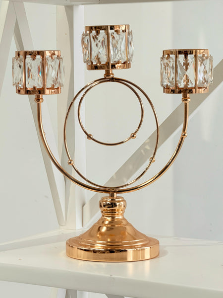 Glamorous gold candle holder with crystals for a luxe setting.