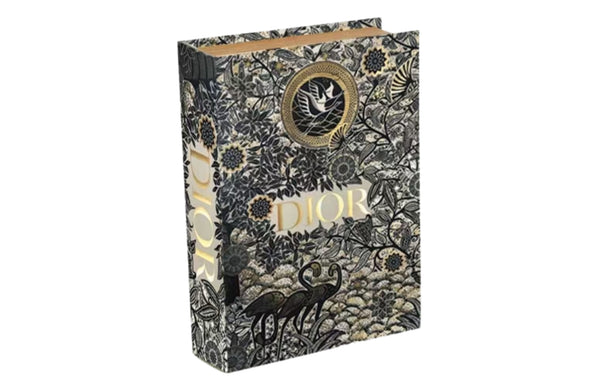 Large black and gold designer faux book box with celestial pattern and hidden storage compartment.