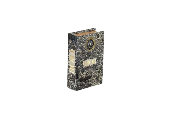 Small black and gold faux book storage box ideal for shelf styling or bedside decor.