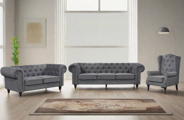 Charcoal grey Chesterfield tufted sofa set with three-seater, two-seater and armchair