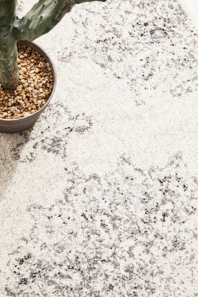 Close-up of Chrome Rita Silver Rug’s intricate texture and soft pile with plant décor.