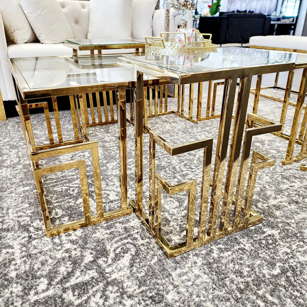 Close-up view of Clara gold coffee table frame and glass top design