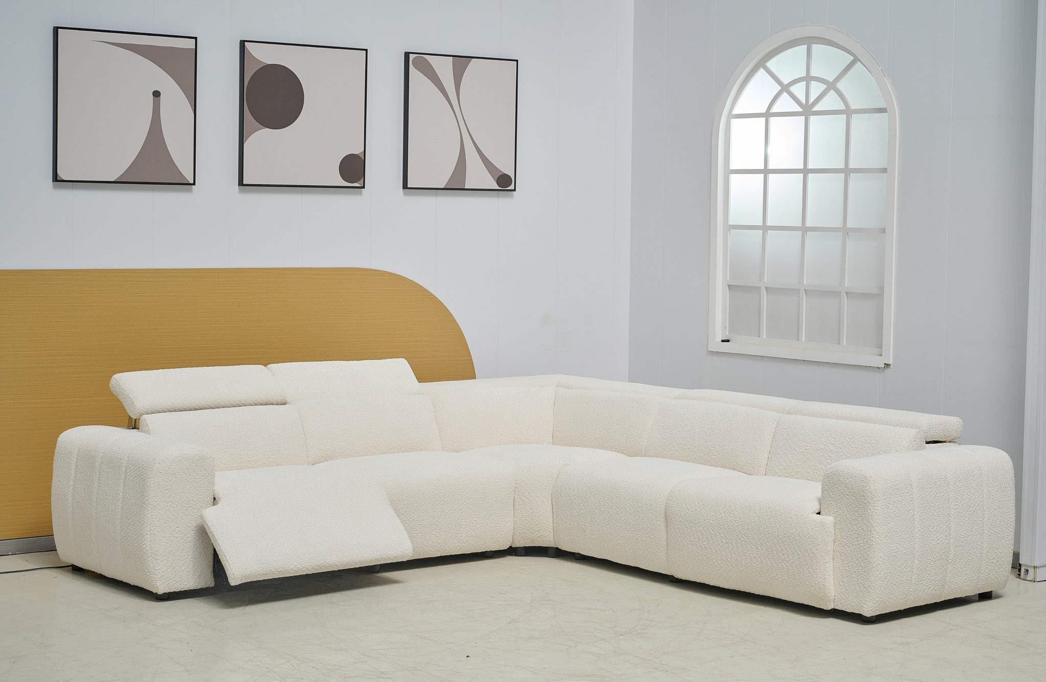 Cream Cleo boucle electric modular lounge styled in living space with powered recliner open.