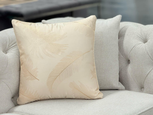 Cream cushion with soft feather pattern, perfect for a calm and elegant touch on sofas or beds
