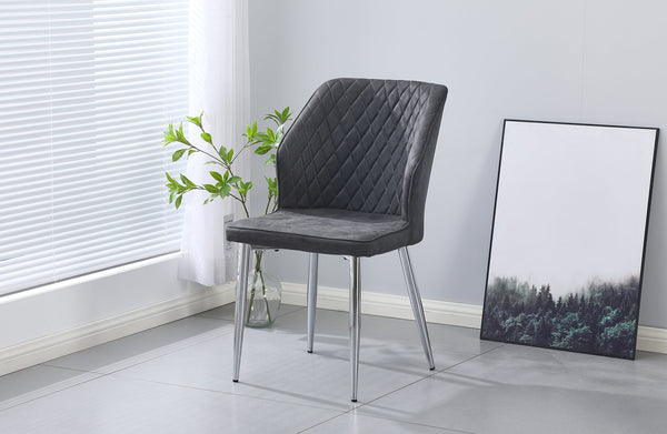 Charcoal cross pattern dining chair with silver legs styled in a bright modern dining room.